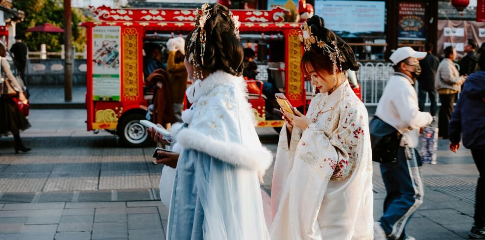 People in traditional attire on a vibrant street in Nanjing, capturing a moment of Chinese culture.