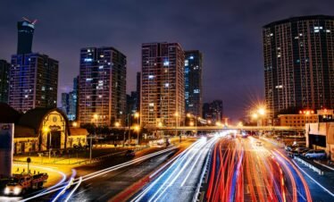 Vibrant long exposure night cityscape in Beijing showcasing urban lights and skyscrapers.