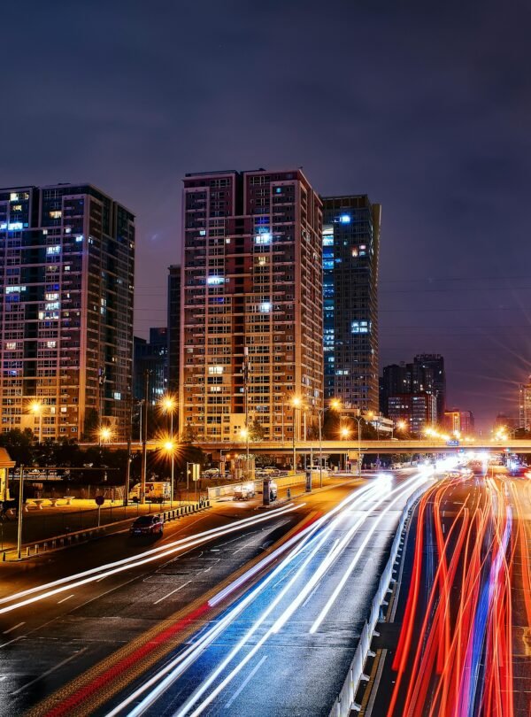 Vibrant long exposure night cityscape in Beijing showcasing urban lights and skyscrapers.