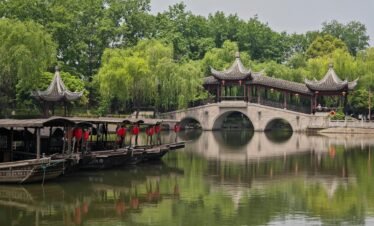 Captivating scene featuring traditional Chinese architecture reflected on a tranquil waterway in Jiaxing.