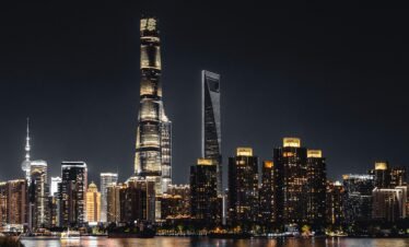 Shanghai skyline illuminated against the night sky featuring iconic skyscrapers.