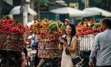 A vibrant street scene in Bac Giang, Vietnam with lychee vendors