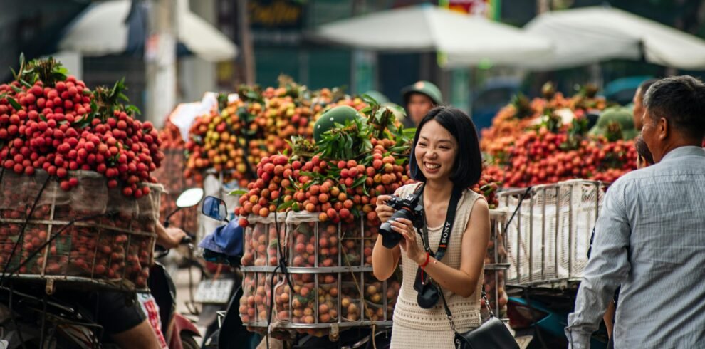 A vibrant street scene in Bac Giang, Vietnam with lychee vendors