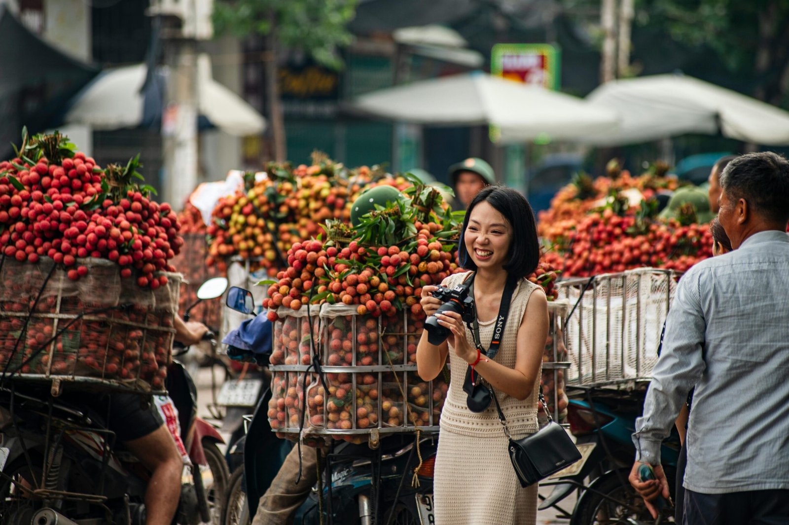 A vibrant street scene in Bac Giang, Vietnam with lychee vendors