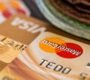 Macro shot of credit cards showing Visa and Mastercard logos next to a wallet, ideal for finance themes.