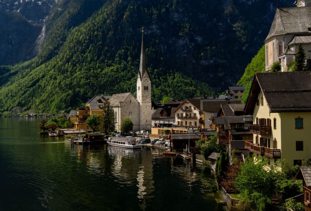 Charming view of Hallstatt with its iconic church by the lake against a backdrop of mountains.