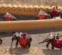 Tourists enjoying elephant rides along a historical fort wall in India, capturing cultural tradition.