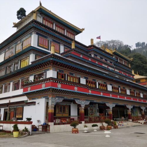 Beautiful Dali Monastery exterior in foggy Darjeeling, India with vibrant architecture.