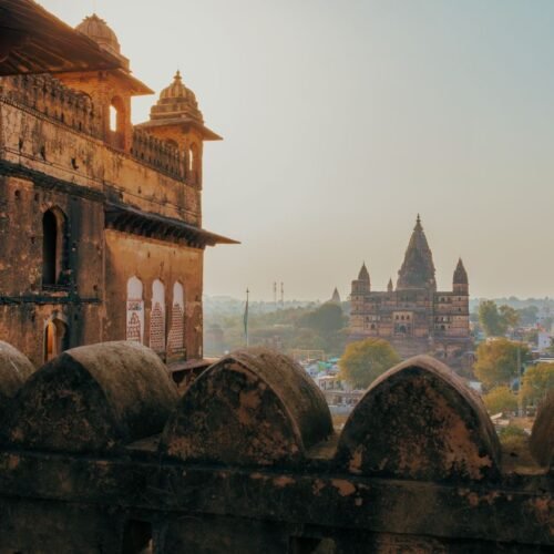 Captivating view of Orchha's ancient temples and fort, showcasing Rajput architecture at sunrise in Madhya Pradesh, India.