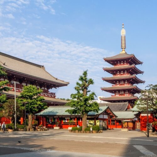 Sunny view of Senso-ji Temple and Five-Storied Pagoda in Tokyo, showcasing traditional Japanese architecture.