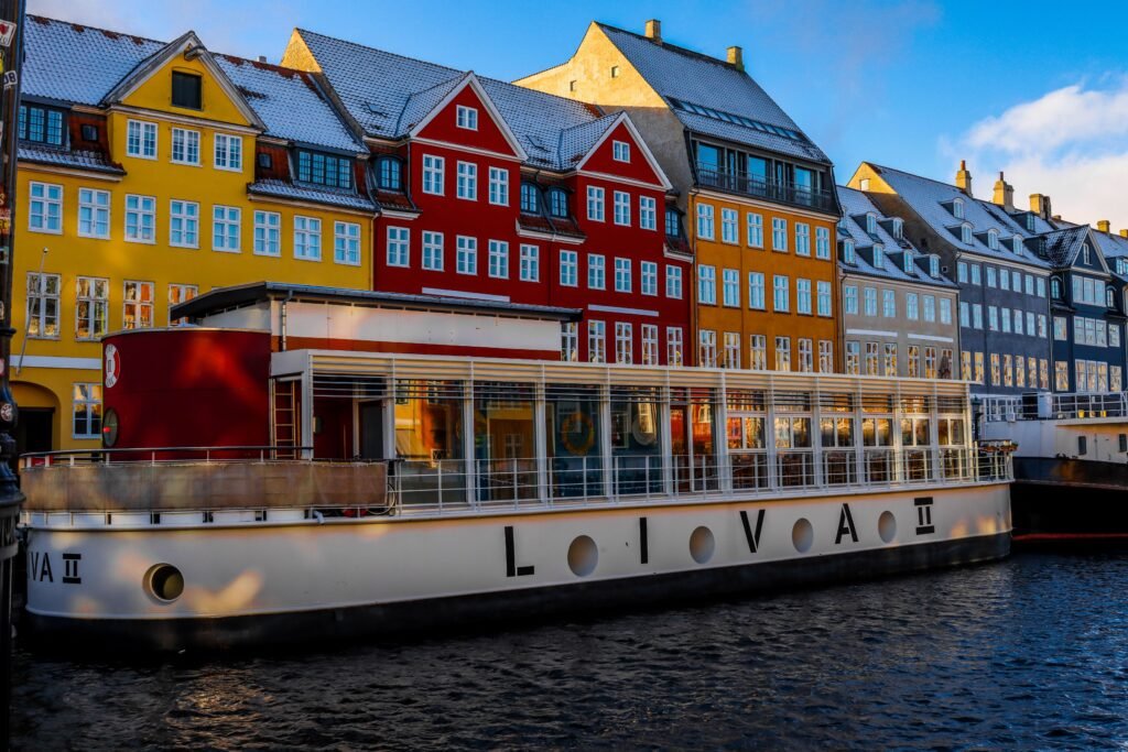 Vibrant buildings and canal boat at Nyhavn, Copenhagen in winter.