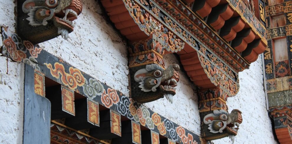 Detailed view of ornate Bhutanese architecture with vibrant dragon motifs.