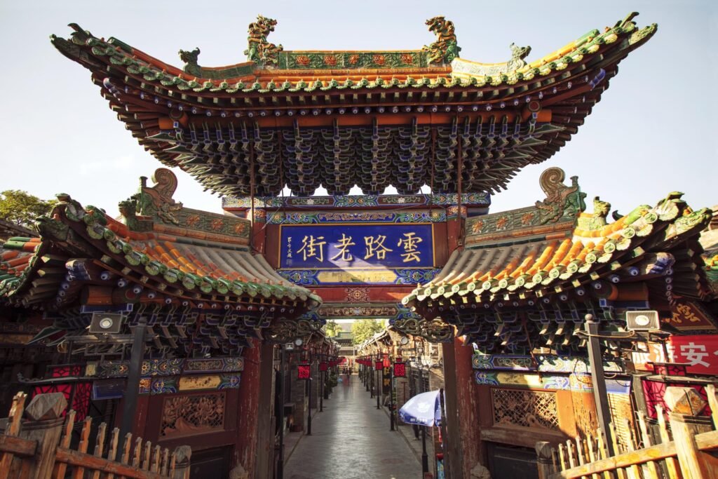 Explore the intricate architecture of an ancient Chinese temple located outdoors during the day.
