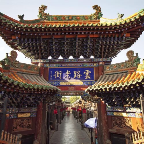 Explore the intricate architecture of an ancient Chinese temple located outdoors during the day.