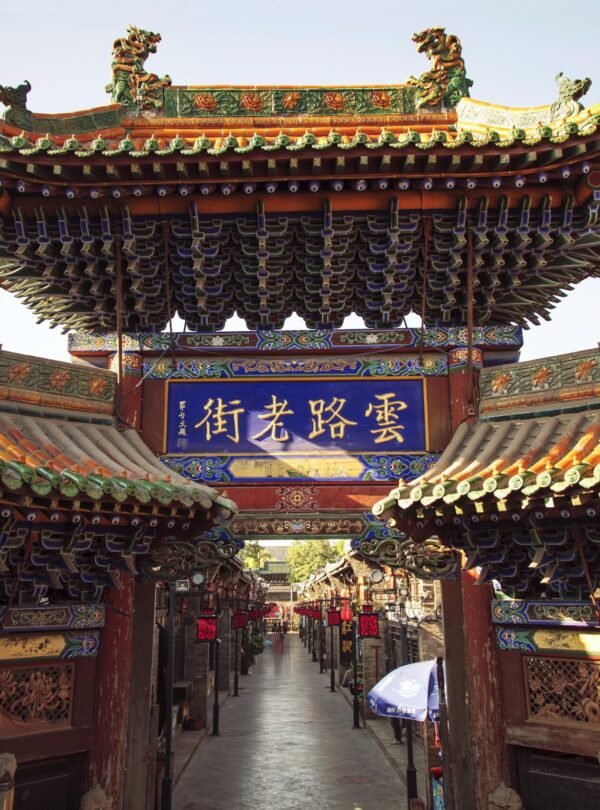 Explore the intricate architecture of an ancient Chinese temple located outdoors during the day.